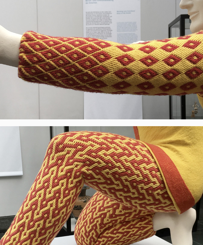 Leg and arm of a plaster sculpture with fabrics showing a zigzag pattern.