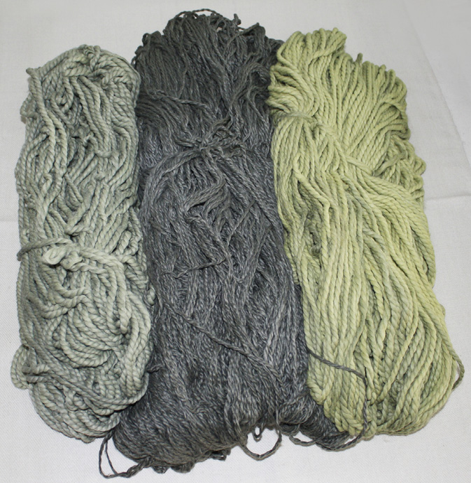 Three skeins of yarn in three different tones of green.